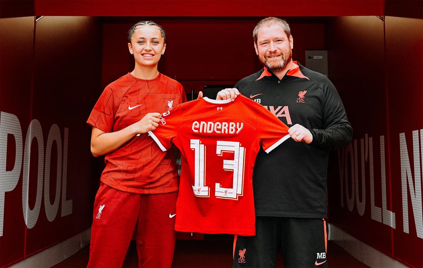 Mia Enderby poses with her shirt and manager Matt Beard after signing for Liverpool FC Women