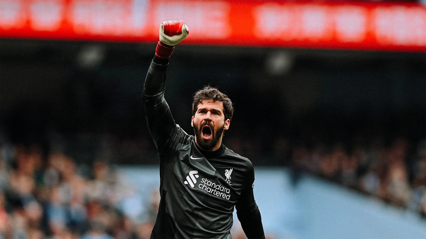 Alisson Becker raises his fist in celebration during a Liverpool match