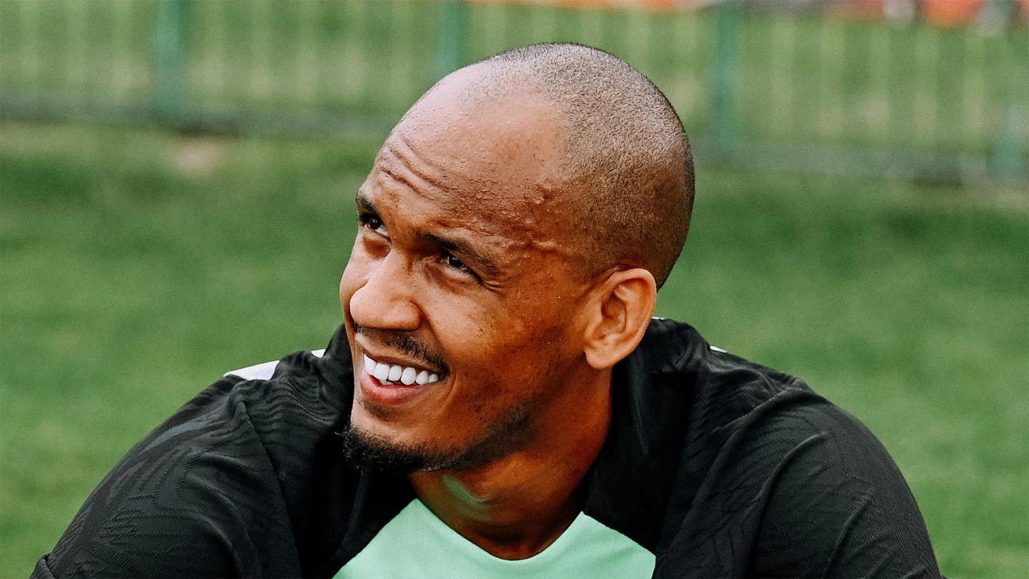 Fabinho sits and smiles as he takes a break from pre-season training at the AXA Training Centre