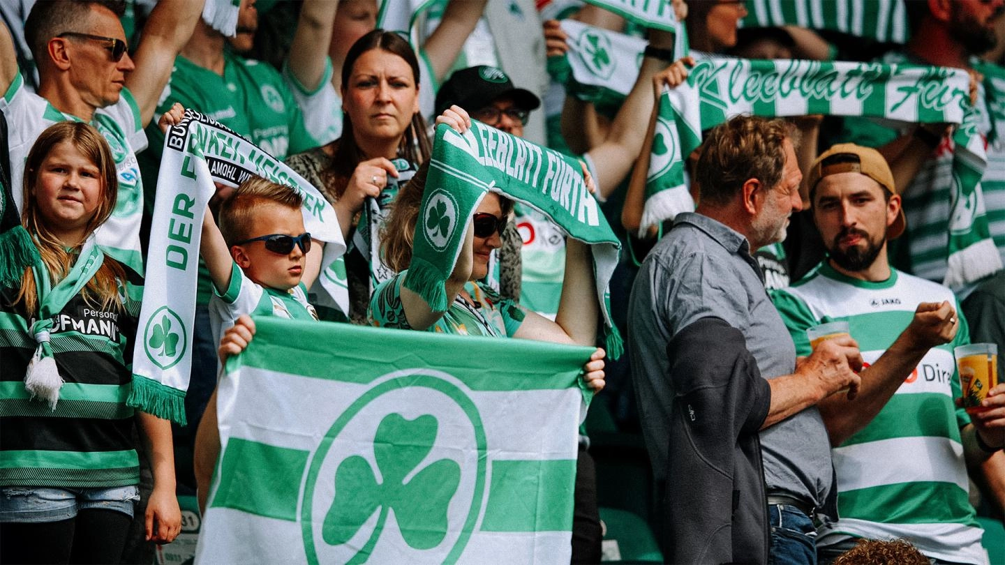 Greuther Furth fans hold up scarves in support of their team