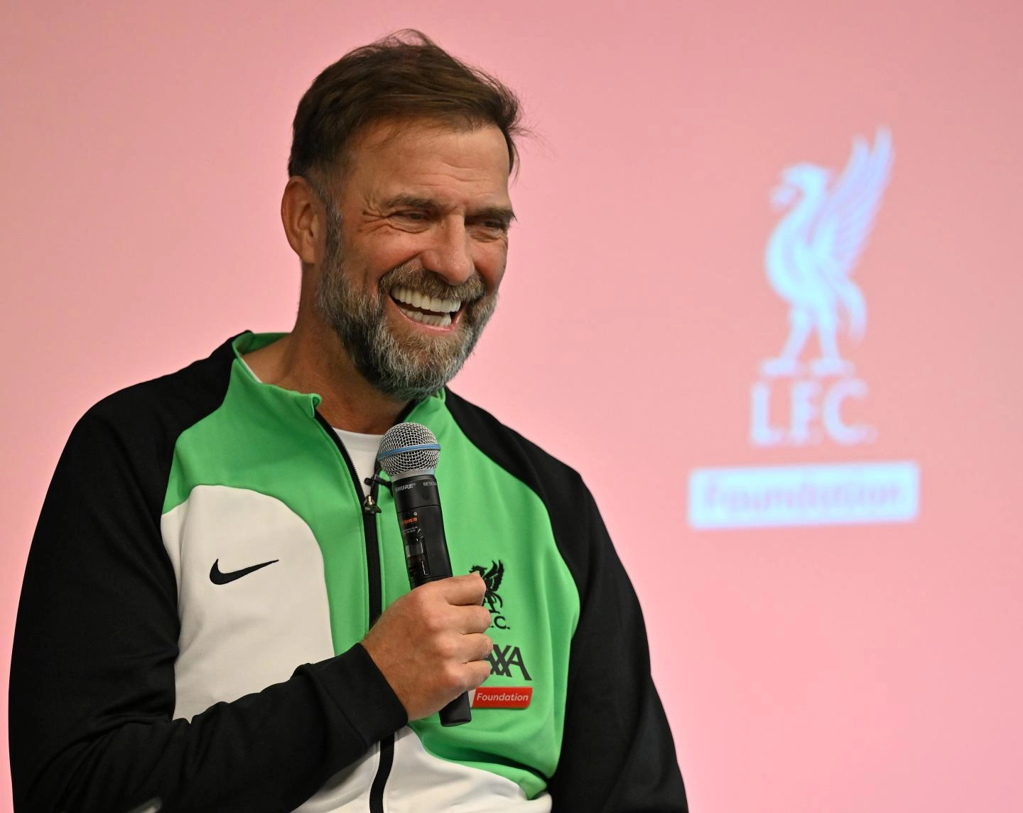 Jürgen Klopp holding a microphone