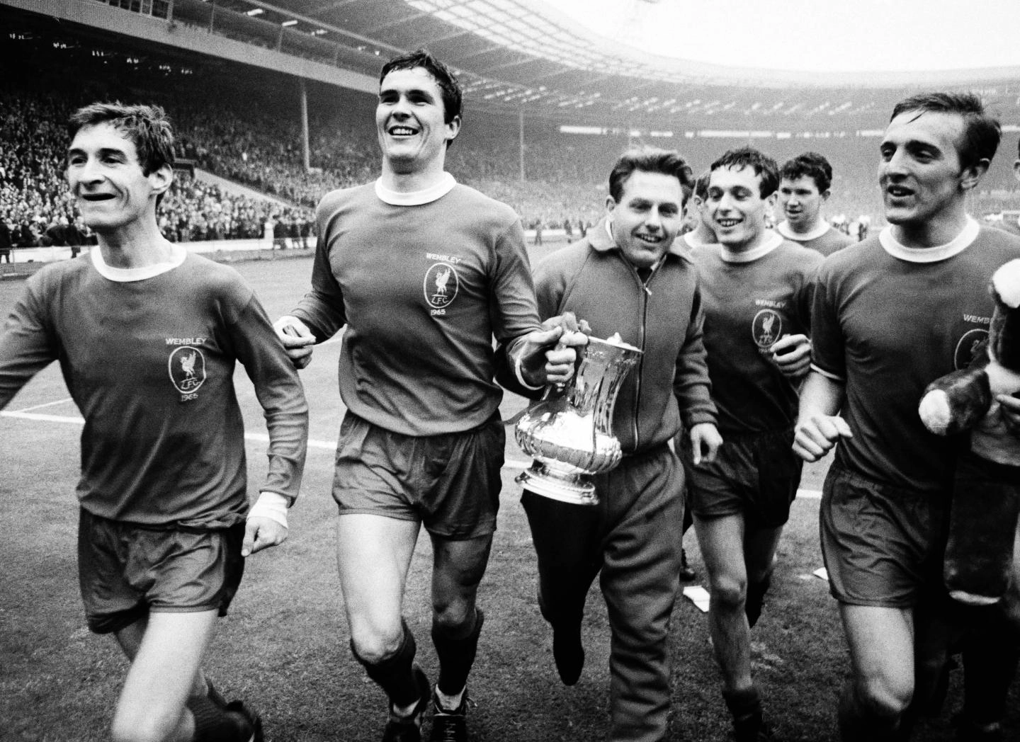 The Reds parade the FA Cup trophy around the pitch