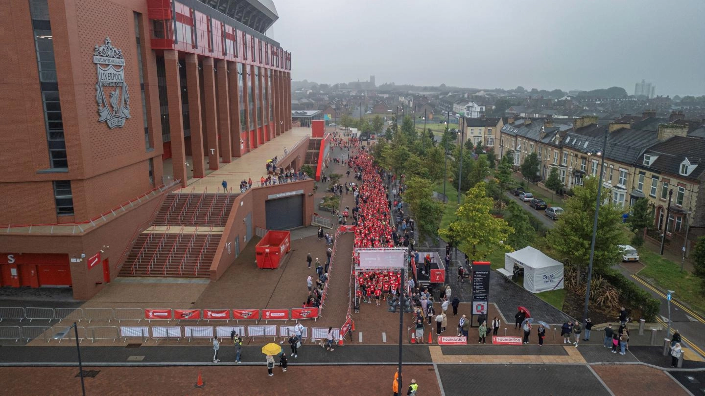 Drone shot of runners outside Anfield Stadium