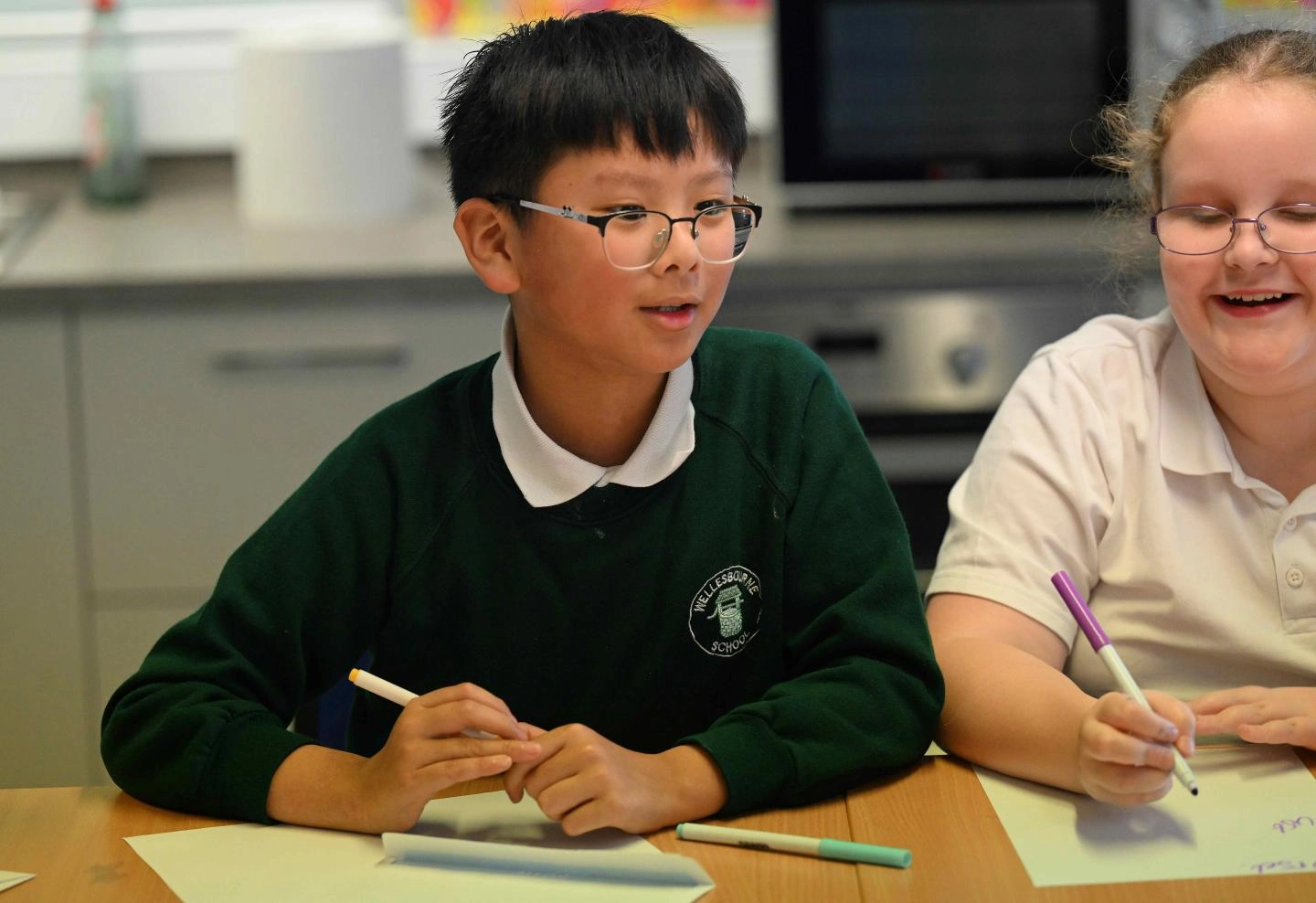 Boy looking up while writing