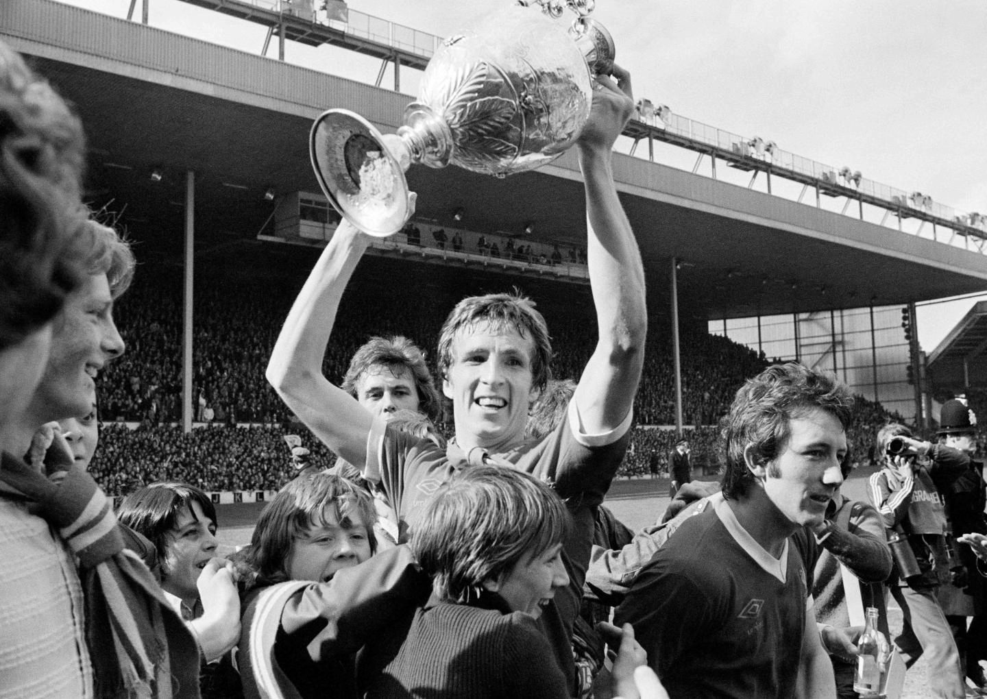 1977: Jones celebrates with the First Division trophy.