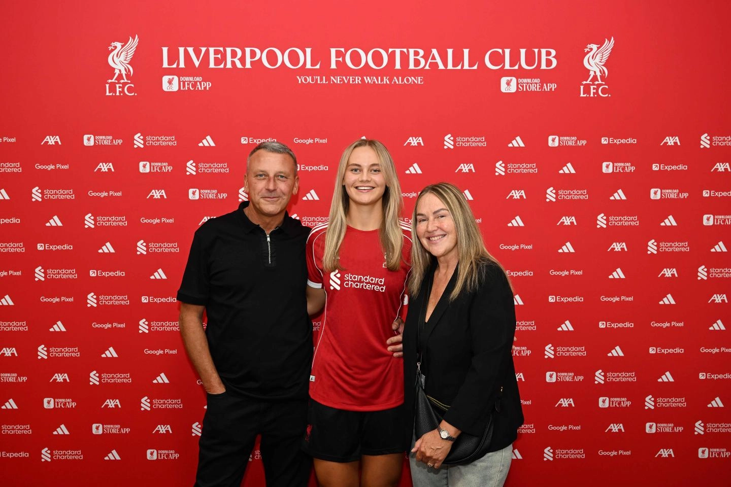 Shaw with her parents after signing her first professional deal