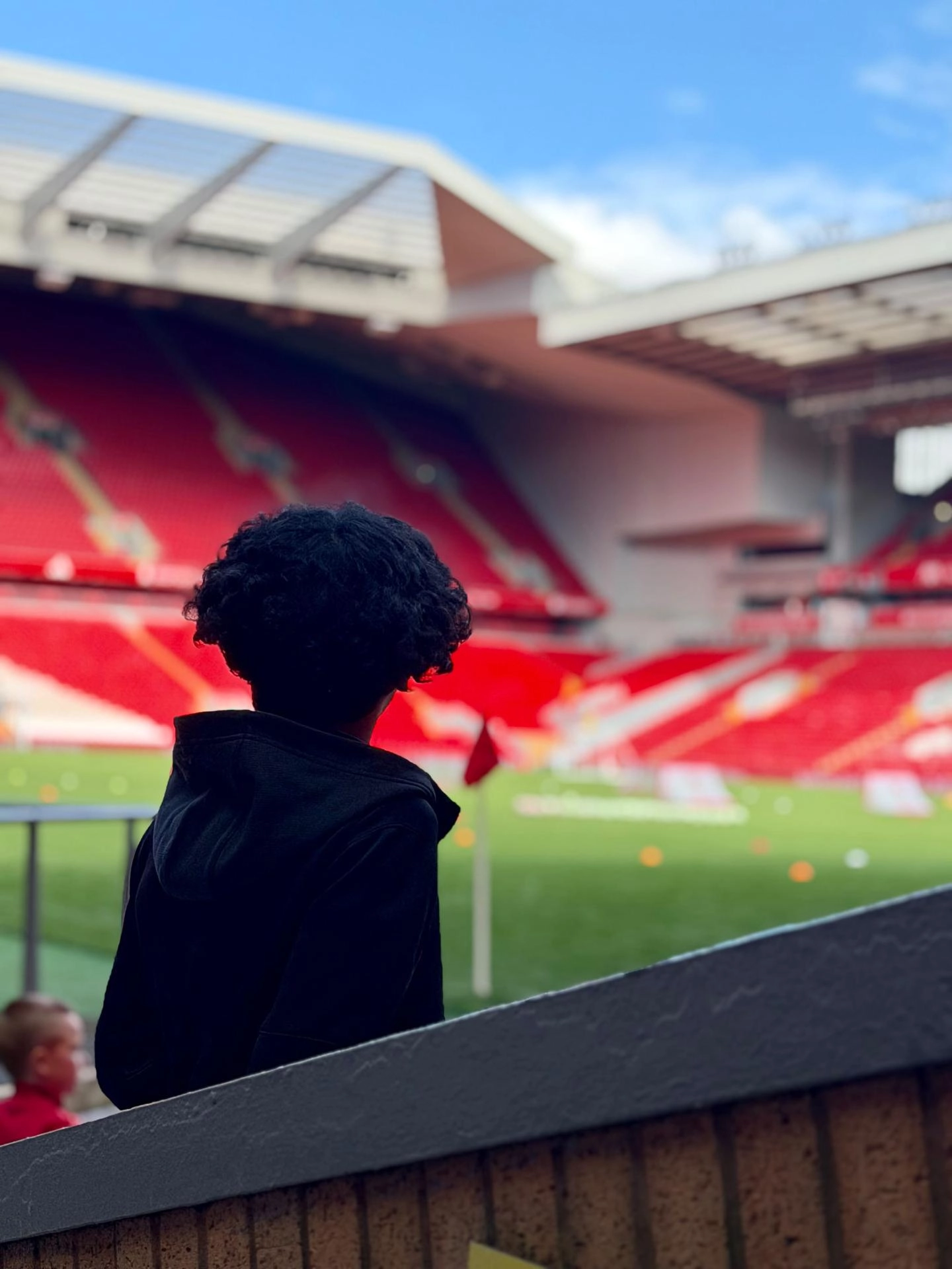 Child looking at the pitch at Anfield Stadium
