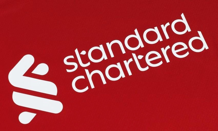 Supporter joins LFC team photo thanks to Standard Chartered Rewards