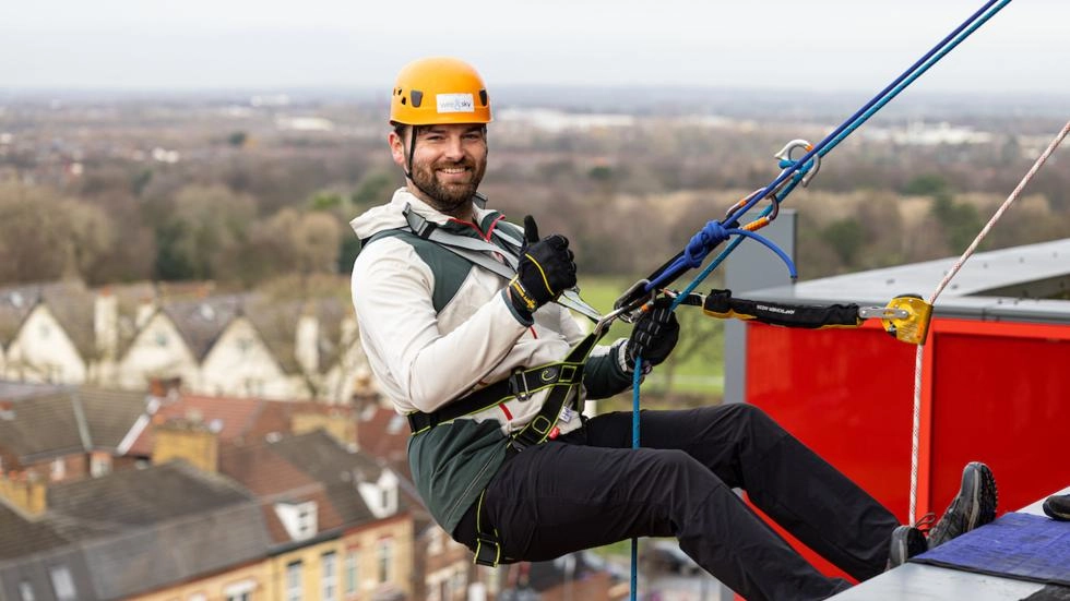 An LFC supporter abseiling from the Main Stand roof