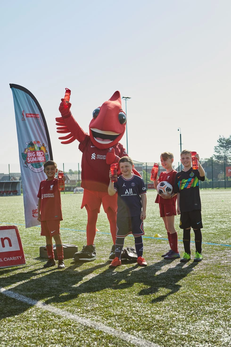 Mighty Red and children at a foundation football session