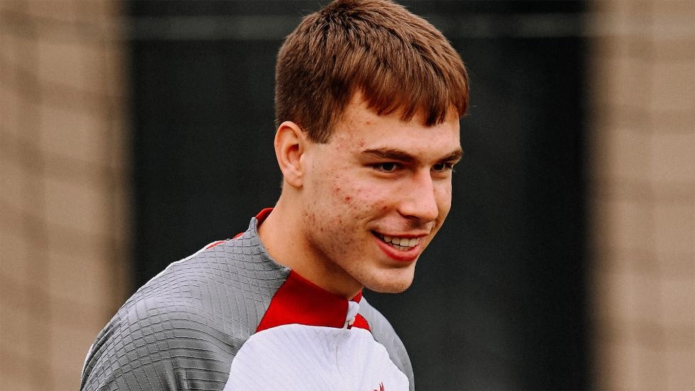 Jakub Ojrzynski smiles during a Liverpool training session