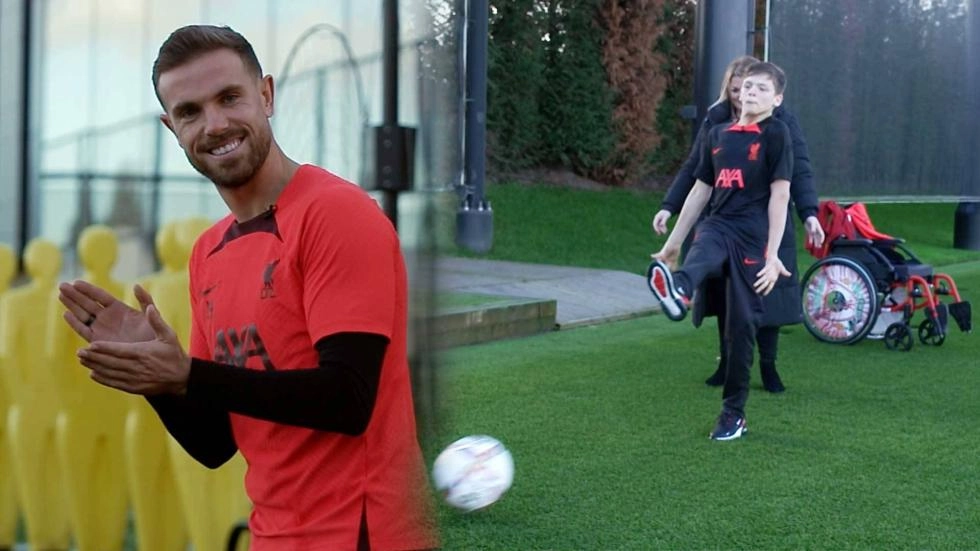 Young Red enjoys kickabout with Jordan Henderson to mark International Day of People with Disabilities